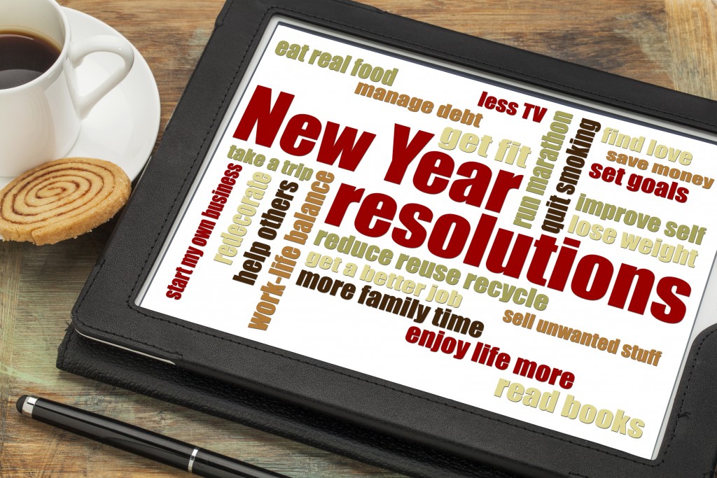 New Year goals or resolutions - a word cloud on a digital tablet with cup of coffee
